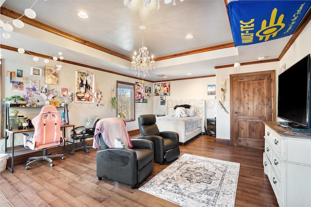 bedroom with crown molding, hardwood / wood-style flooring, and an inviting chandelier