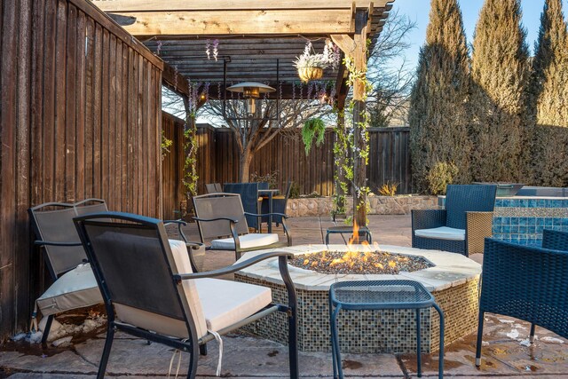 view of patio with a pergola and a fire pit