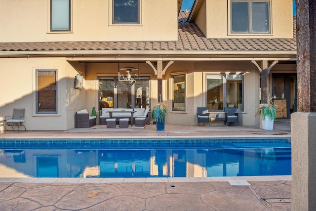 back of property featuring an outdoor living space and a patio area