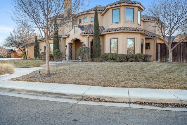 mediterranean / spanish home featuring a front yard