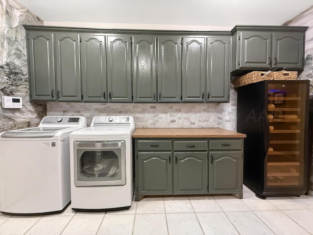 8 Glenbrook Dr, Borger, TX 79007 - washroom with cabinet space, separate washer and dryer, wine cooler, and light tile patterned floors