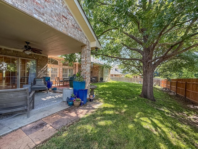 8 Glenbrook Dr, Borger, TX 79007 - fenced backyard with a ceiling fan and a patio