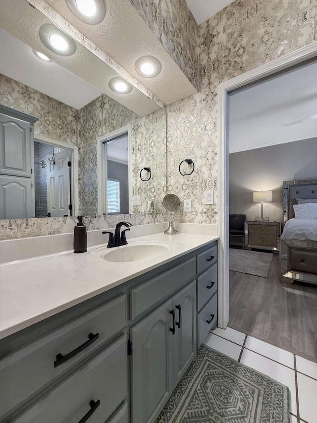 8 Glenbrook Dr, Borger, TX 79007 - ensuite bathroom featuring vanity, tile patterned flooring, and wallpapered walls