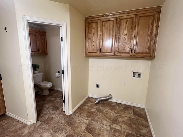 washroom with hookup for an electric dryer, cabinets, and washer hookup