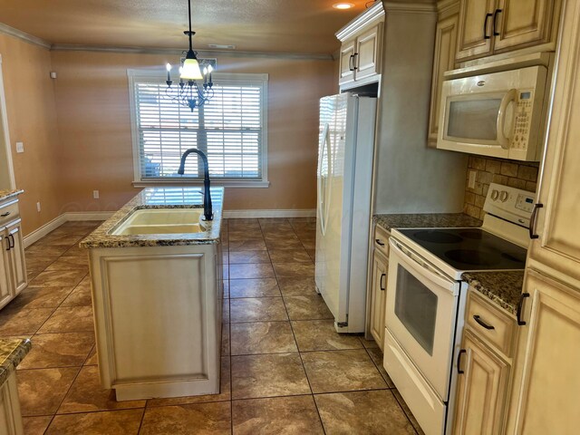 kitchen with pendant lighting, white appliances, a kitchen island with sink, sink, and a notable chandelier