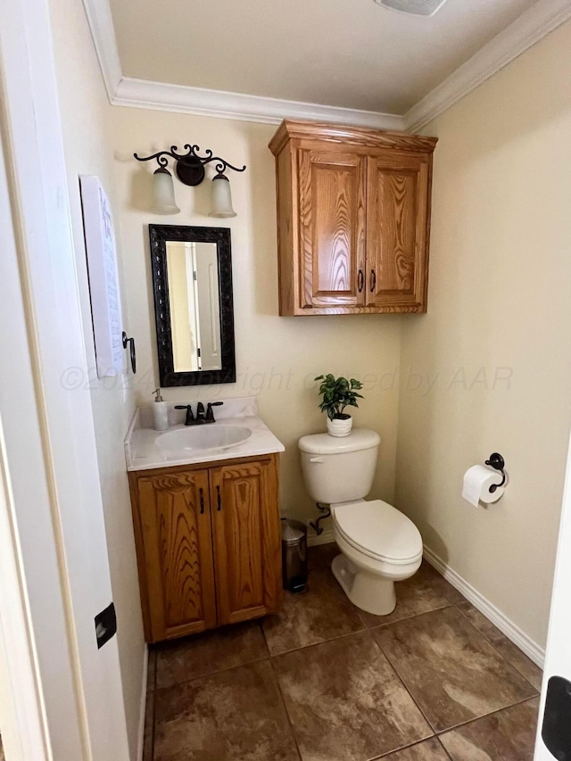 bathroom featuring vanity, toilet, and ornamental molding