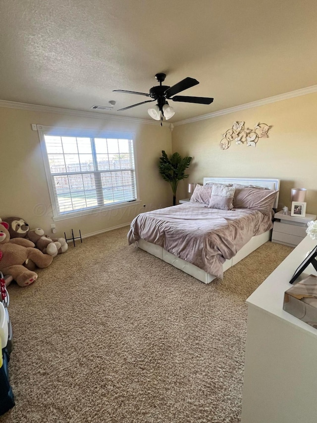 bedroom with carpet flooring, ceiling fan, a textured ceiling, and ornamental molding