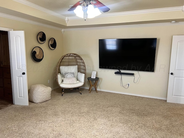 living area featuring ceiling fan, carpet floors, and ornamental molding