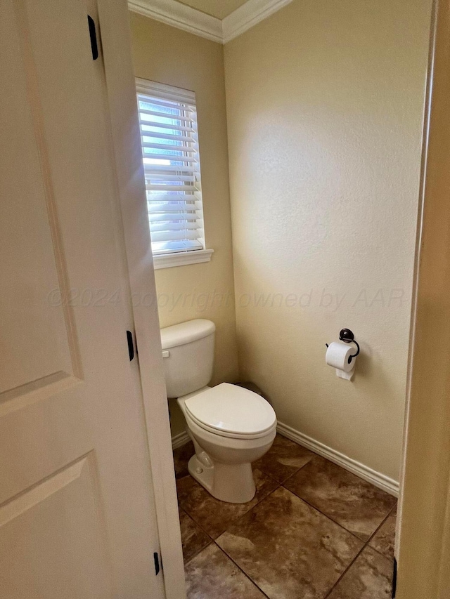 bathroom with tile patterned floors, ornamental molding, and toilet