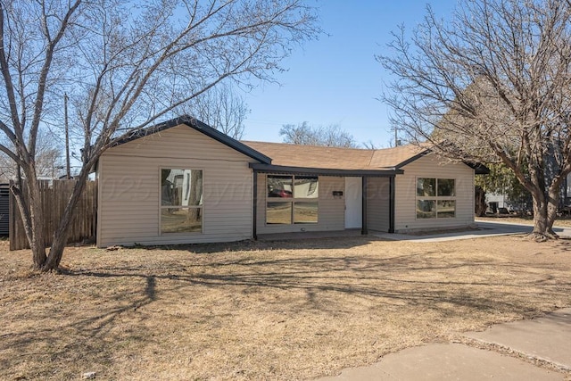 single story home with fence