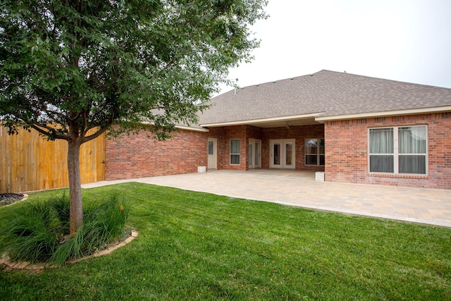 5401 Walesa Ct, Amarillo, TX 79119 - back of house with roof with shingles, brick siding, and a patio