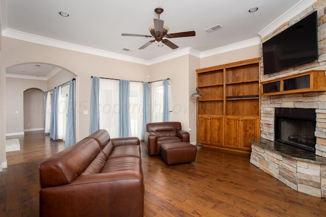 5401 Walesa Ct, Amarillo, TX 79119 - living room with ceiling fan, hardwood / wood-style floors, a fireplace, arched walkways, and ornamental molding