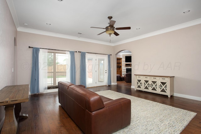 5401 Walesa Ct, Amarillo, TX 79119 - living room with arched walkways, ceiling fan, dark wood finished floors, crown molding, and a fireplace