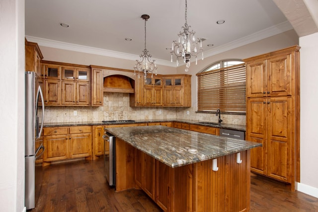 5401 Walesa Ct, Amarillo, TX 79119 - kitchen featuring a chandelier, brown cabinets, a center island, ornamental molding, and recessed lighting
