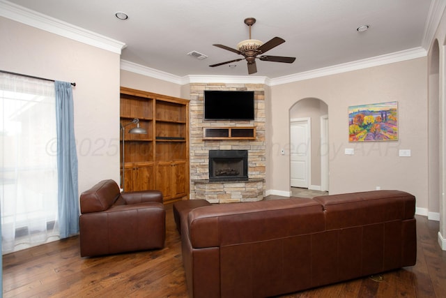 5401 Walesa Ct, Amarillo, TX 79119 - living room featuring ceiling fan, wood finished floors, crown molding, a fireplace, and arched walkways