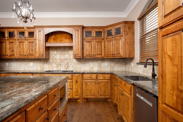 5401 Walesa Ct, Amarillo, TX 79119 - kitchen with stainless steel appliances, brown cabinets, custom exhaust hood, and crown molding