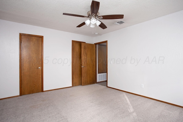 7408 Sleepy Hollow Blvd, Amarillo, TX 79121 - unfurnished bedroom with carpet flooring, baseboards, ceiling fan, and a textured ceiling