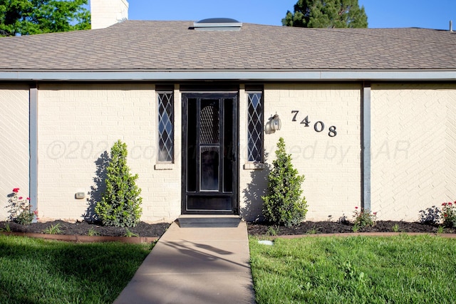 7408 Sleepy Hollow Blvd, Amarillo, TX 79121 - doorway to property with a shingled roof, brick siding, and a chimney