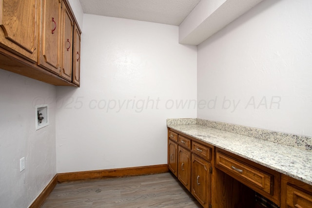 7408 Sleepy Hollow Blvd, Amarillo, TX 79121 - laundry area with cabinet space, light wood-style floors, hookup for a washing machine, baseboards, and a textured ceiling