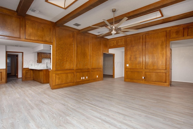7408 Sleepy Hollow Blvd, Amarillo, TX 79121 - unfurnished living room with beamed ceiling, a ceiling fan, light wood finished floors, and wood walls