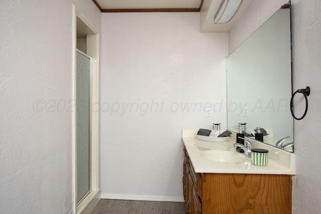 7408 Sleepy Hollow Blvd, Amarillo, TX 79121 - full bath featuring a stall shower, wood finished floors, vanity, ornamental molding, and baseboards
