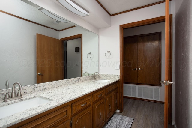 7408 Sleepy Hollow Blvd, Amarillo, TX 79121 - bathroom with wood finished floors, double vanity, and crown molding