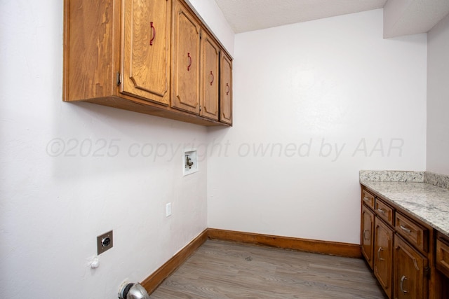 7408 Sleepy Hollow Blvd, Amarillo, TX 79121 - laundry area featuring cabinet space, light wood finished floors, baseboards, and electric dryer hookup