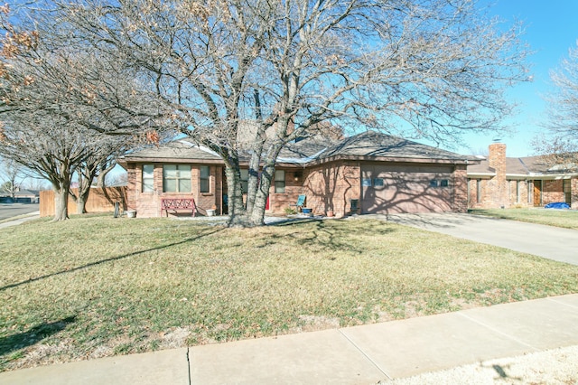 ranch-style house featuring a front lawn and a garage