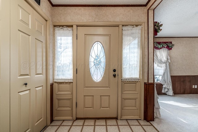 2723 County Road O, Friona, TX 79035 - entrance foyer featuring light carpet, a textured ceiling, and wainscoting