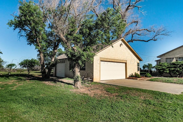 2723 County Road O, Friona, TX 79035 - view of side of home featuring stucco siding, a yard, a garage, and driveway