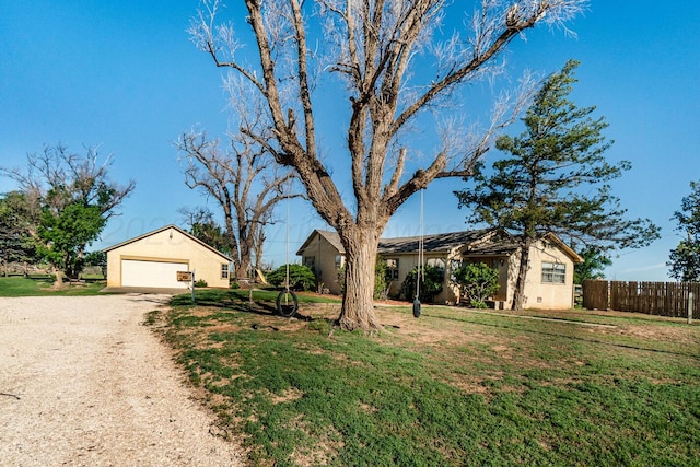 2723 County Road O, Friona, TX 79035 - ranch-style house with driveway, stucco siding, a detached garage, and an outbuilding