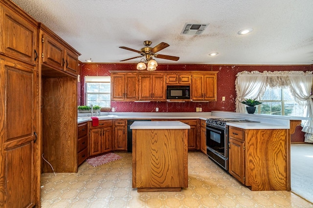 2723 County Road O, Friona, TX 79035 - kitchen with black appliances, a center island, light countertops, brown cabinets, and a textured ceiling