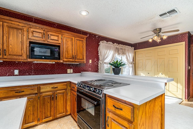 2723 County Road O, Friona, TX 79035 - kitchen with black appliances, a peninsula, a textured ceiling, light countertops, and brown cabinetry