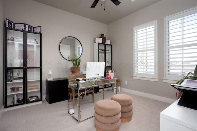 carpeted home office with ceiling fan