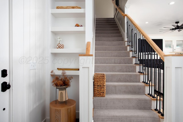 stairs featuring ceiling fan and built in features