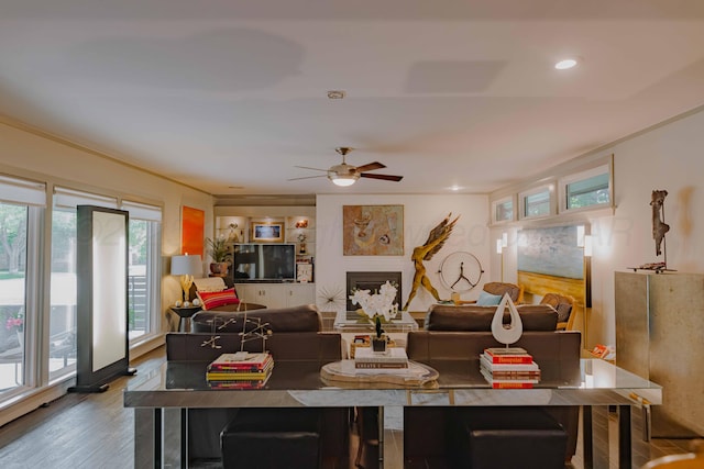living room with wood finished floors, a ceiling fan, crown molding, and recessed lighting