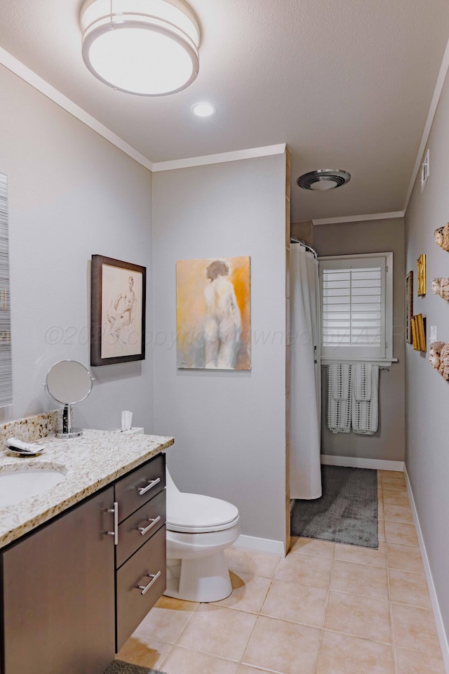 bathroom with crown molding, vanity, toilet, tile patterned floors, and baseboards