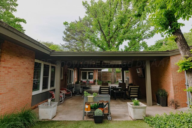view of patio / terrace with an outdoor hangout area, fence, and a ceiling fan