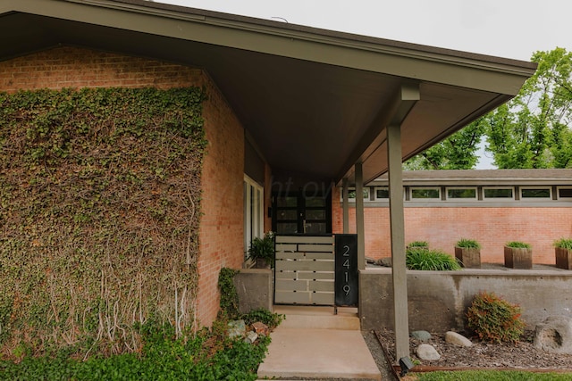 property entrance with brick siding