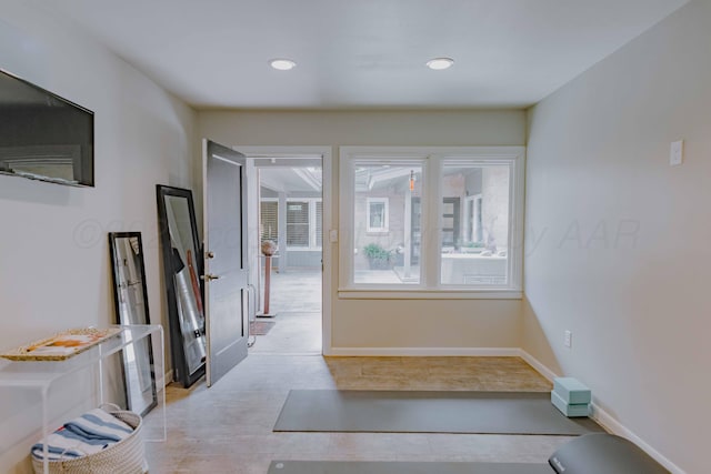 hallway featuring recessed lighting and baseboards