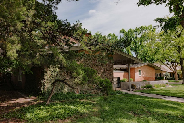 view of front facade with a front yard and a chimney
