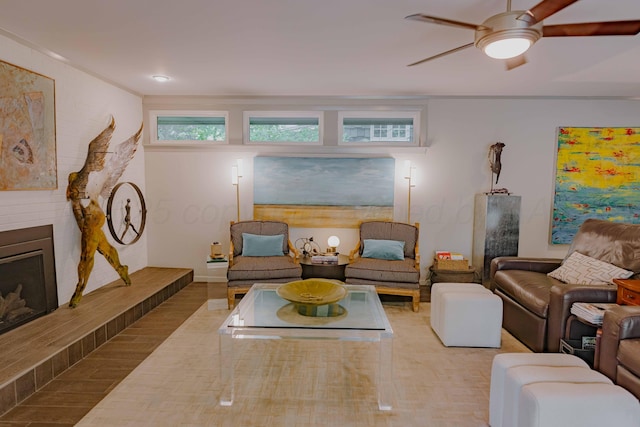 living room with a ceiling fan and a large fireplace