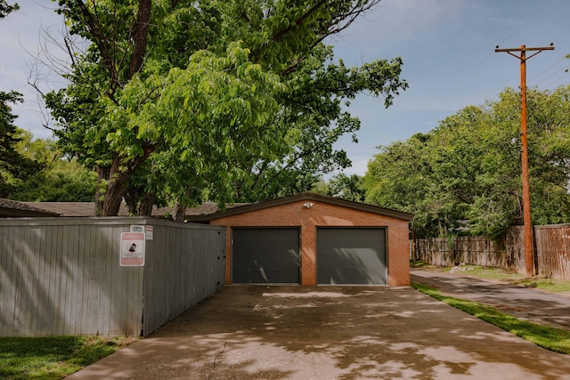 detached garage with fence and a gate