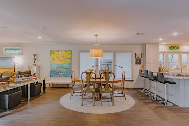 dining space featuring dark wood-style flooring and recessed lighting