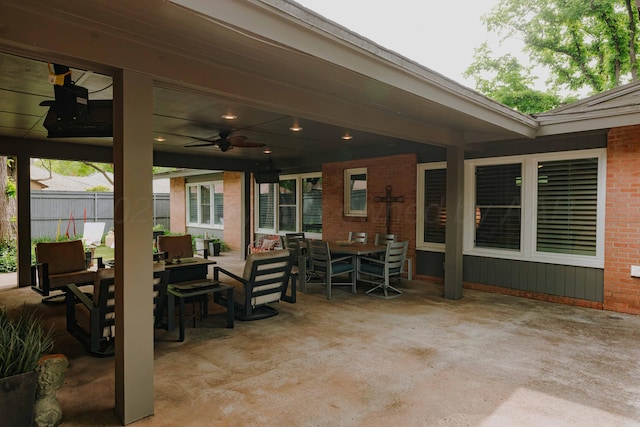 view of patio / terrace with outdoor dining space, ceiling fan, and fence