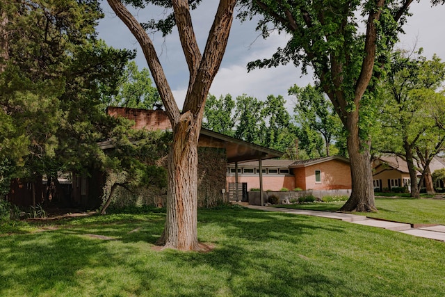 view of front facade with a front yard and brick siding