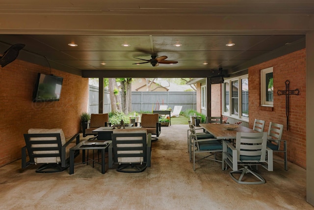 view of patio featuring outdoor dining area, fence, ceiling fan, and an outdoor hangout area