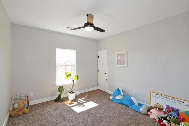 rec room featuring carpet flooring and ceiling fan