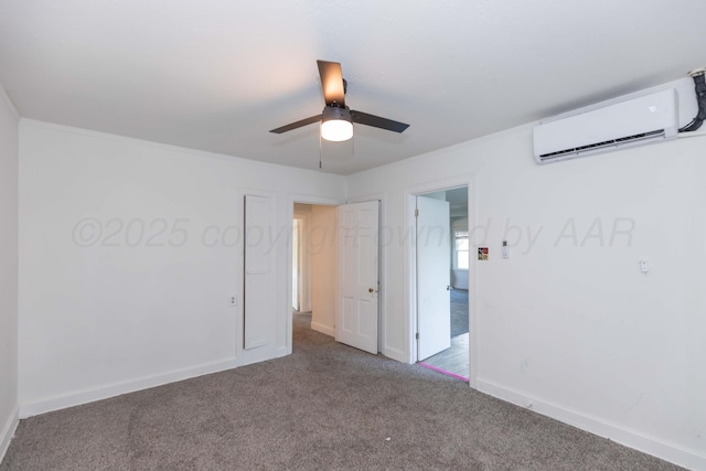 empty room featuring a wall mounted air conditioner, carpet flooring, ceiling fan, baseboards, and crown molding