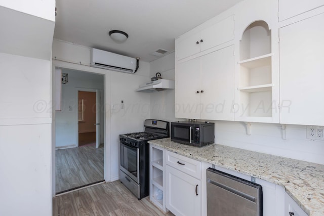 kitchen featuring open shelves, stainless steel appliances, a wall mounted air conditioner, and white cabinetry